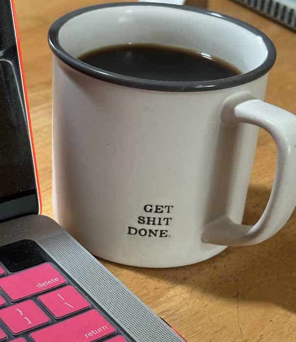 photo-of-coffee-mug-next-to-computer